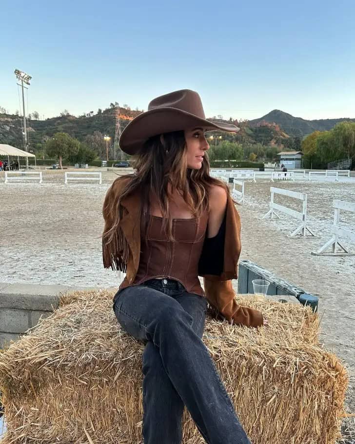 country-concert-outfit-ideas-sexy-brown-corset-top-fringe-jacket-bootcut-jeans