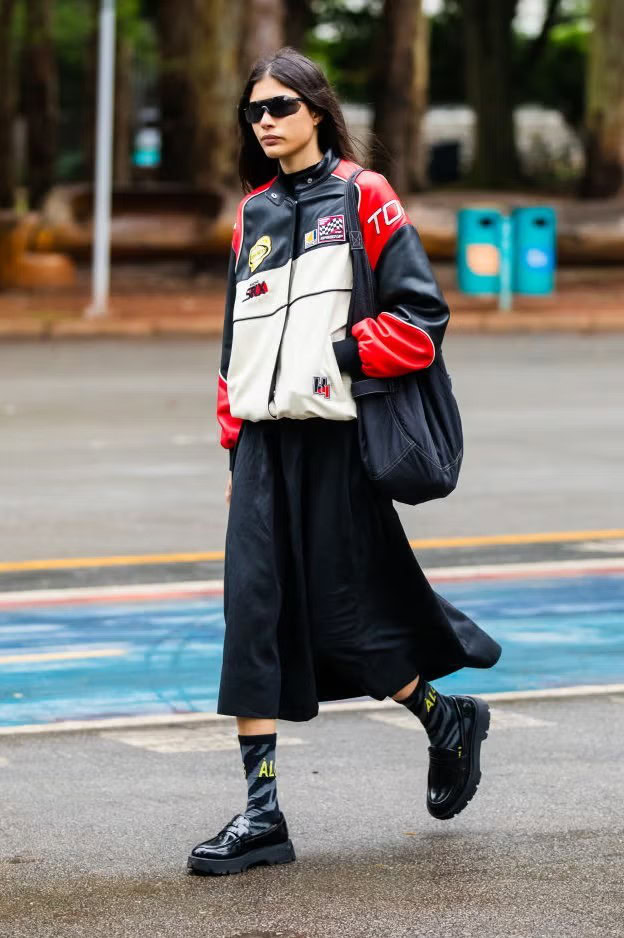 guest-wears-racing-jacket-black-midi-skirt-black-chunky-news-photo-1730833308