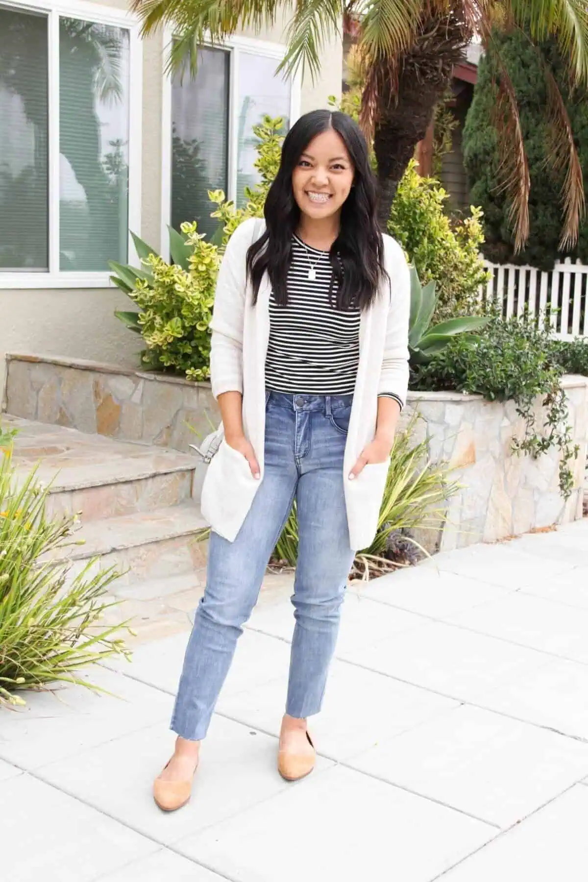 Black-and-white-striped-long-sleeve-tee-light-straight-leg-raw-hem-jeans-cream-long-cardigan-tan-suede-flats-gold-pendant-necklace-gray-crossbody-bag-scaled